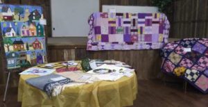 Quilts and other fabric art is displayed during the show.